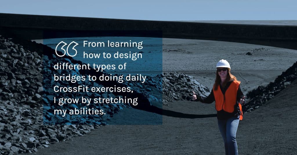 Kellie Hernandez, who designs bridges, is pictured standing giving the camera a thumbs up in front of a bridge in the Arizona desert. 