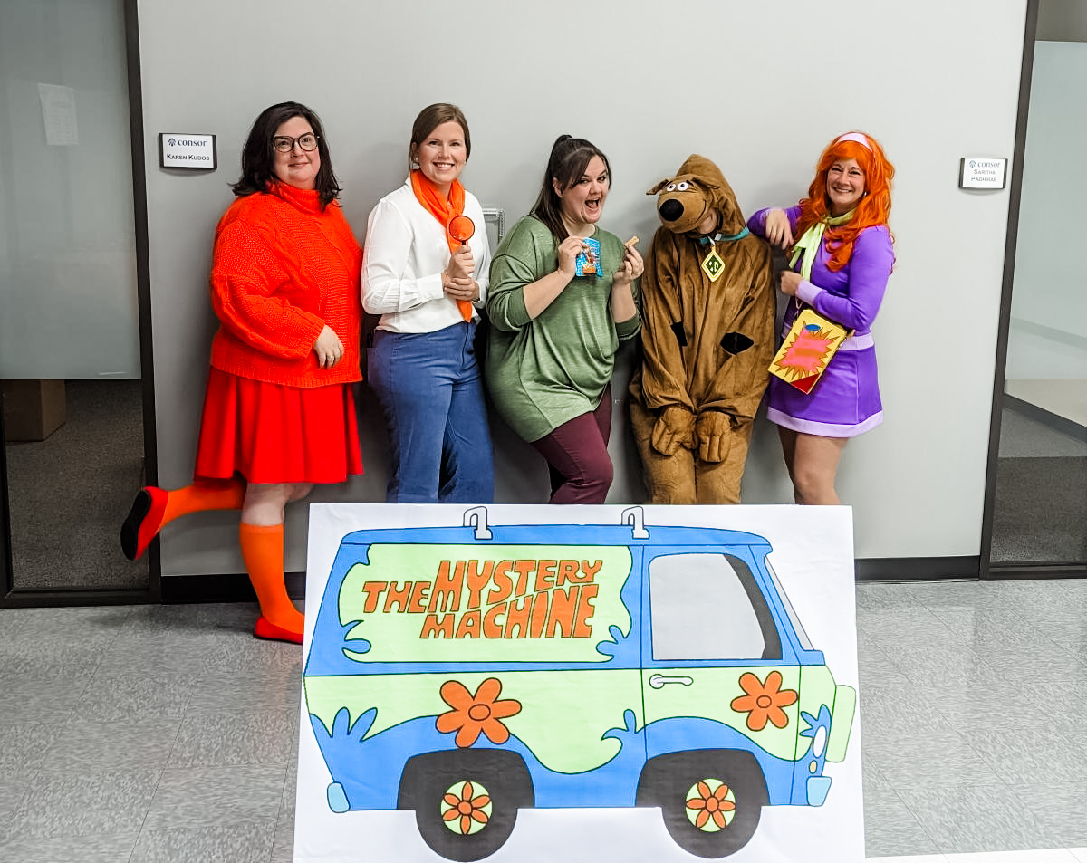 Celebrating at a Consor Halloween party in Scooby-Doo costumes.